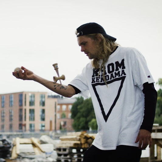 man played kendama with tricks 